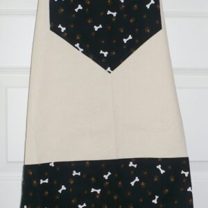 Beige and black apron with bone patterns, suitable for dog lovers.