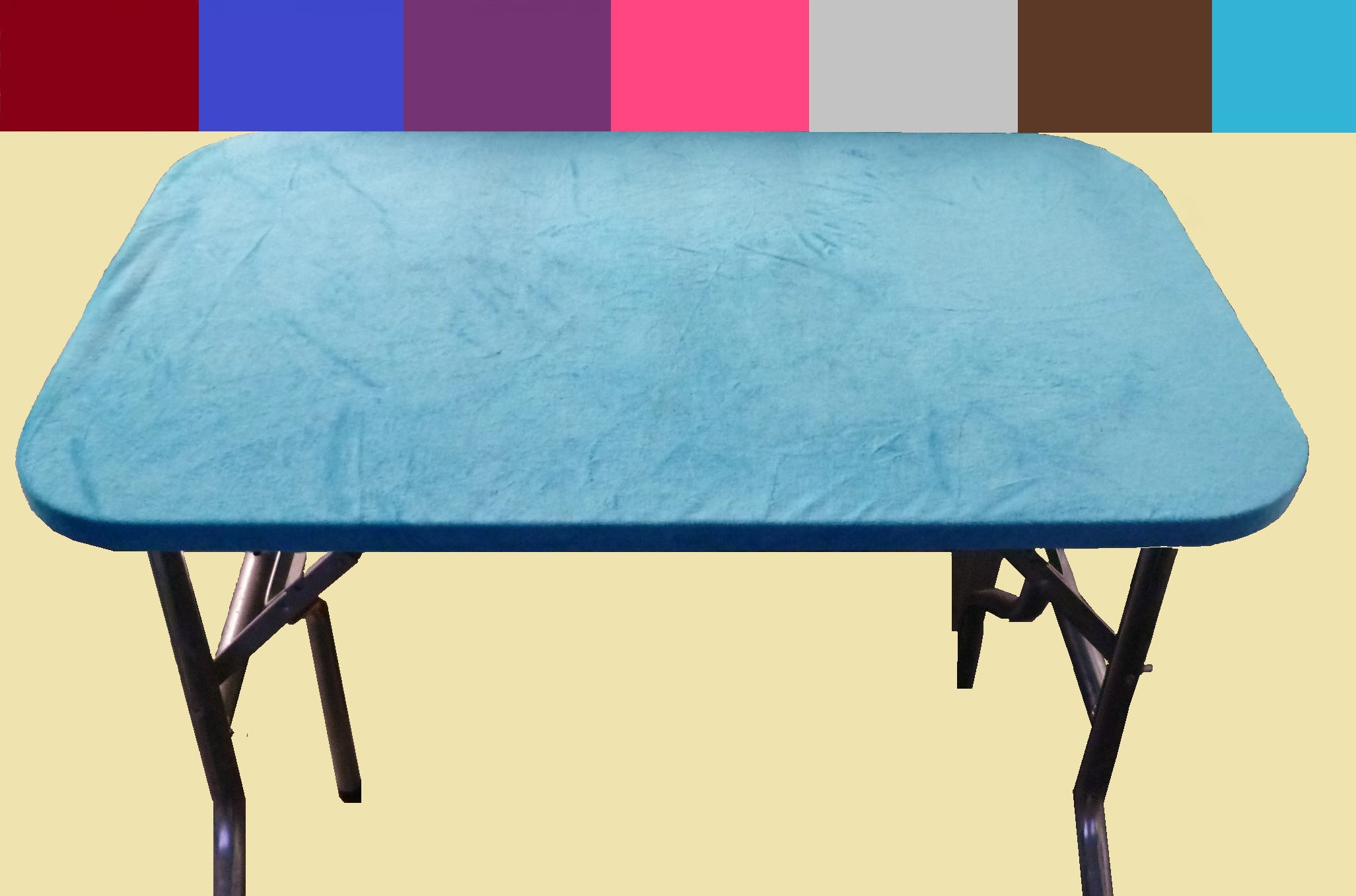 Blue massage table with black folding legs on a white background.