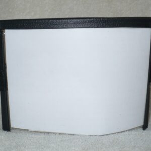 Blank whiteboard with black frame on a carpeted floor.