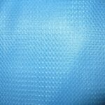 Close-up of textured blue fabric surface.