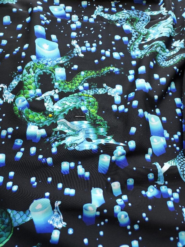 Green dragons and floating candles on fabric
