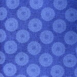 Blue circular pattern on textured fabric background.