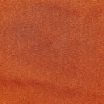 Orange textured fabric close-up view.