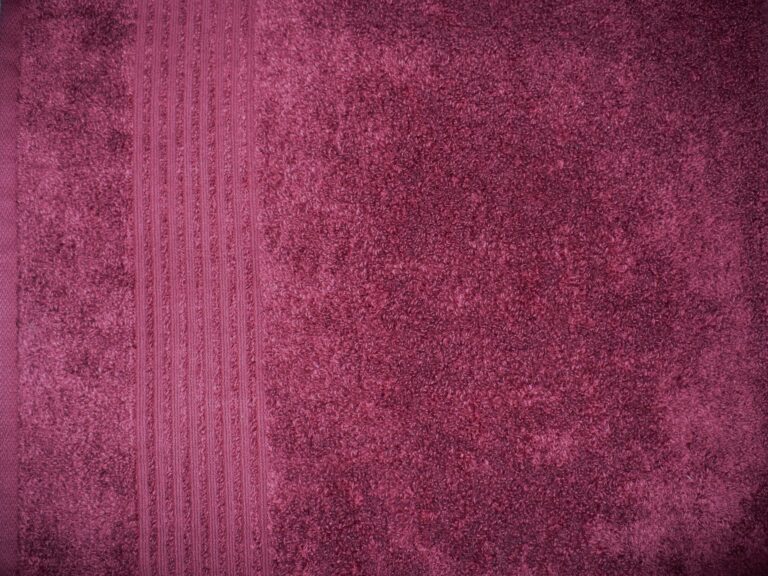 Maroon textured fabric with vertical stripes