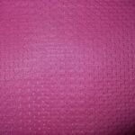 Pink textured fabric with small patterns.