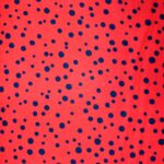 Red fabric with blue polka dot pattern.