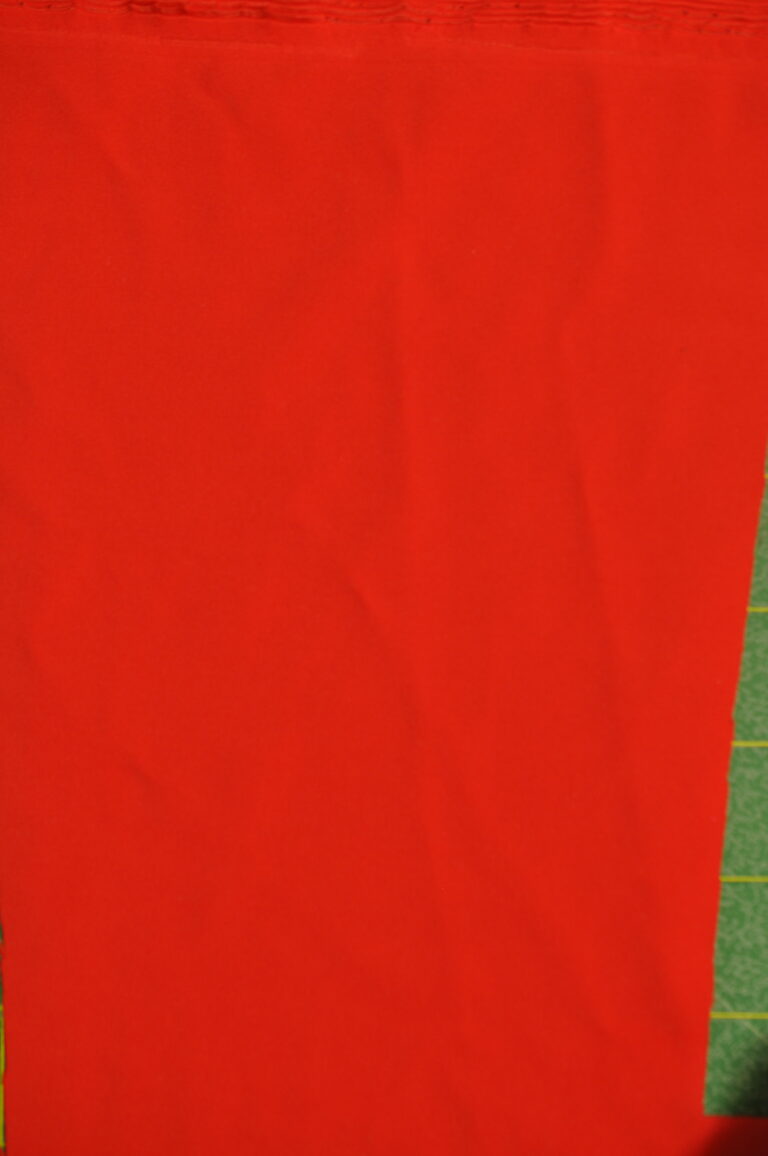 Red fabric with green grid background
