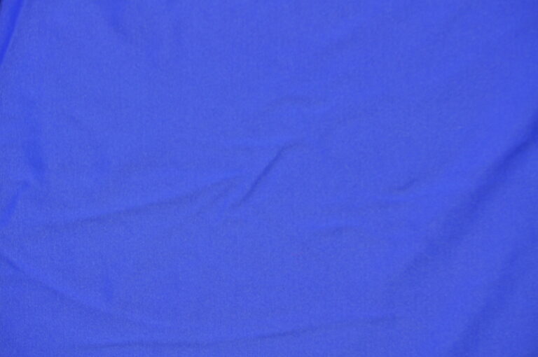 Solid blue fabric with visible creases
