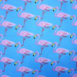Pattern of pink flamingos on blue background.