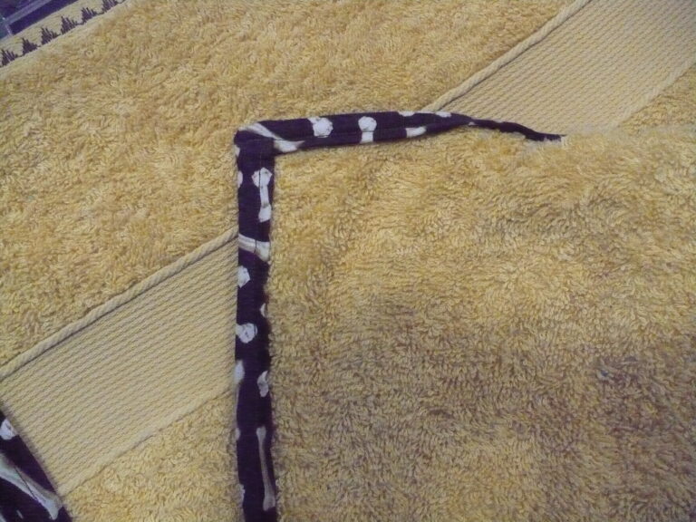 Yellow towel with dark patterned border
