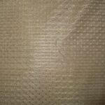 Beige textured fabric close-up view.