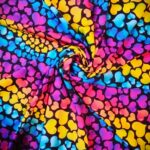 Colorful heart-patterned fabric, swirling design.