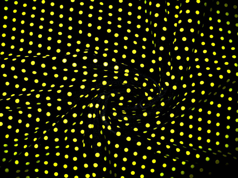 Yellow polka dots on black fabric