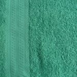 Green textured towel with decorative stripe.