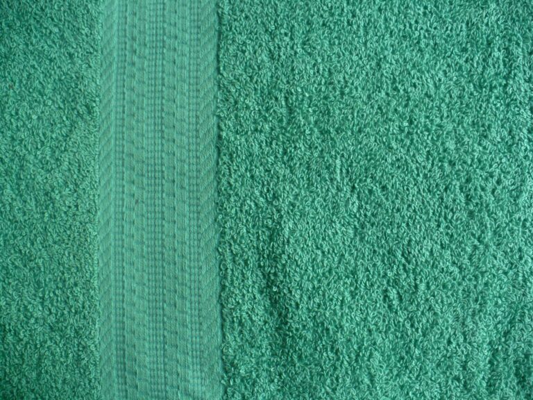 Green textured towel with decorative stripe