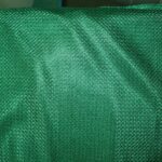 Green textured fabric with subtle pattern.