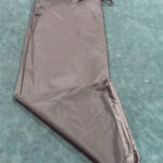 A folded pair of brown pants on a blue surface.