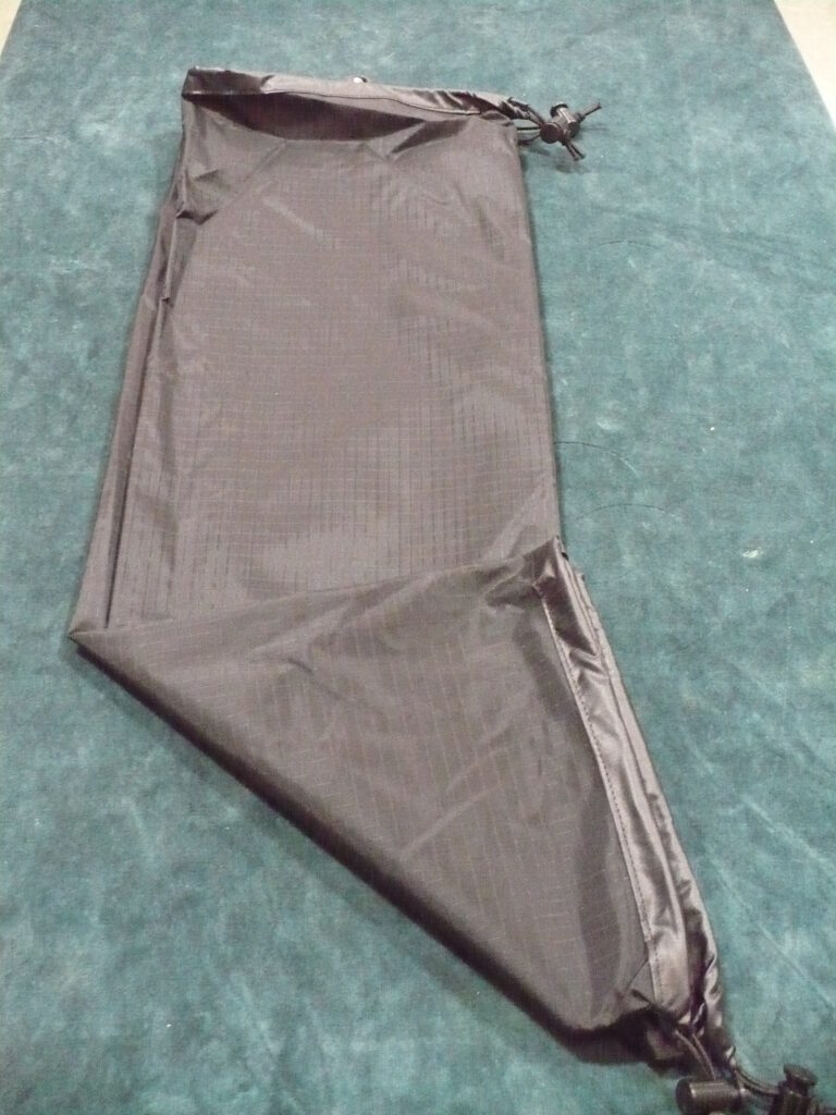 A folded pair of brown pants on a blue surface