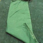 Green satin or silk fabric laid out flat.