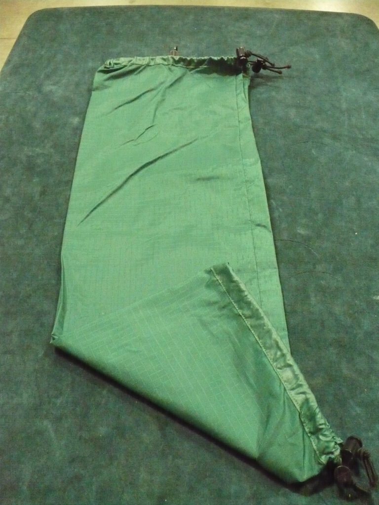 Green satin or silk fabric laid out flat