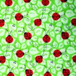 Pattern of red ladybugs on green leaves.