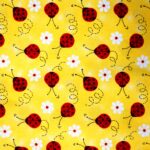 Ladybugs and flowers pattern on yellow background.