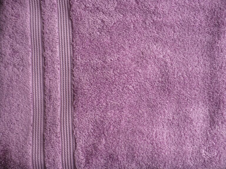 Purple textured towel with striped edge