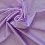 Purple fabric with elegant folds and texture.