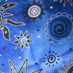 Blue fabric with celestial sun and stars.