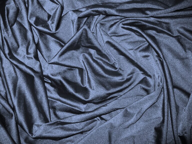 Dark blue satin fabric with folds