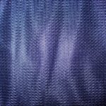 Blue textured fabric with woven pattern.