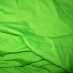 Bright green fabric with soft folds.