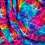 Colorful neon swirl pattern on fabric.