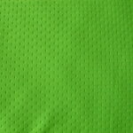 Green textured fabric with small perforations.