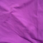 Purple fabric with soft folds and creases.