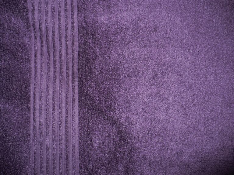 Purple textured fabric with vertical stripes