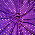 Purple fabric with orange polka dot pattern.