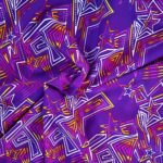Purple fabric with colorful geometric star patterns.