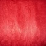 Red textured fabric close-up pattern.