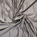Gray fabric with gathered draping folds.