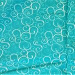 Teal fabric with white swirling patterns.